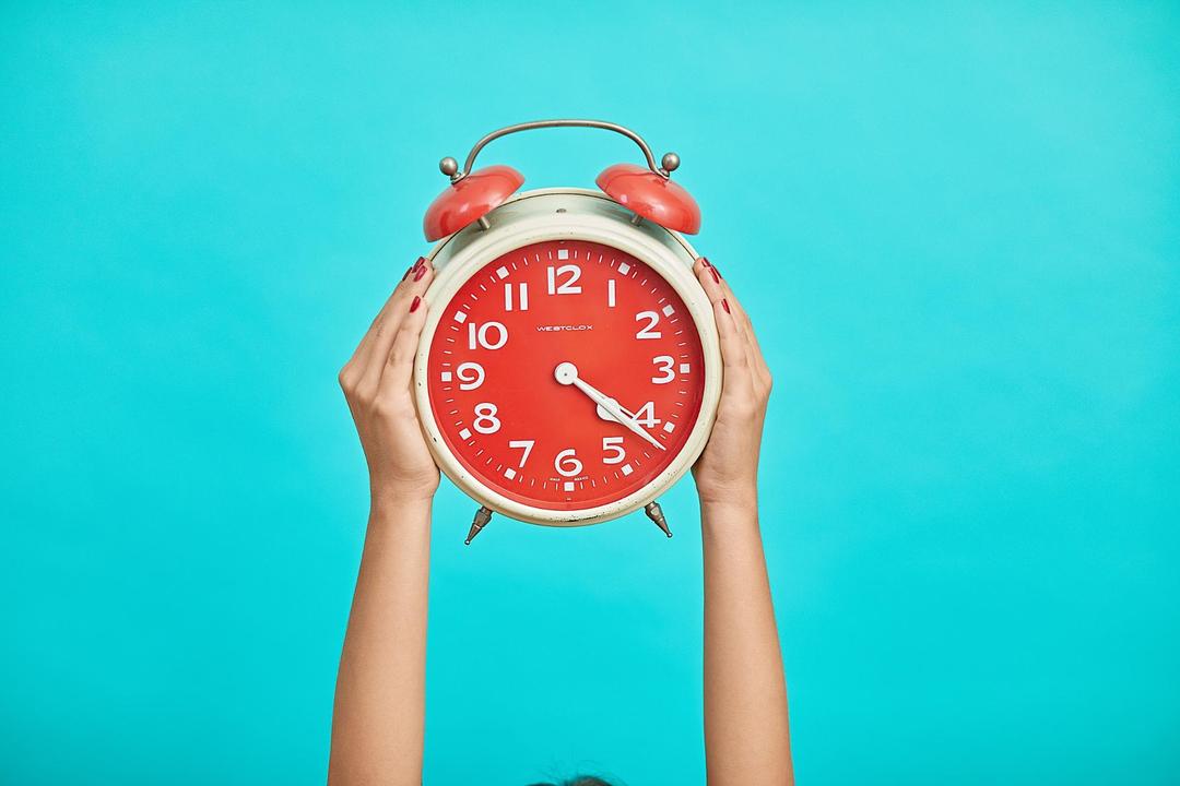 woman holding intermittent fasting clock up