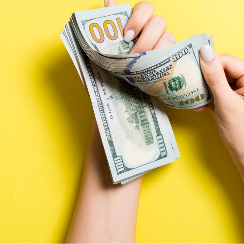 Hand holding money wondering how much money do I need to start?