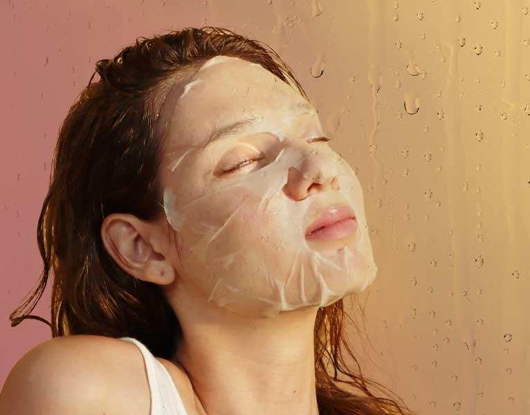 a woman using sheet mask