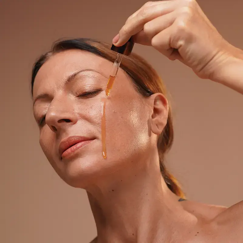 woman dropping a stream of golden years on face