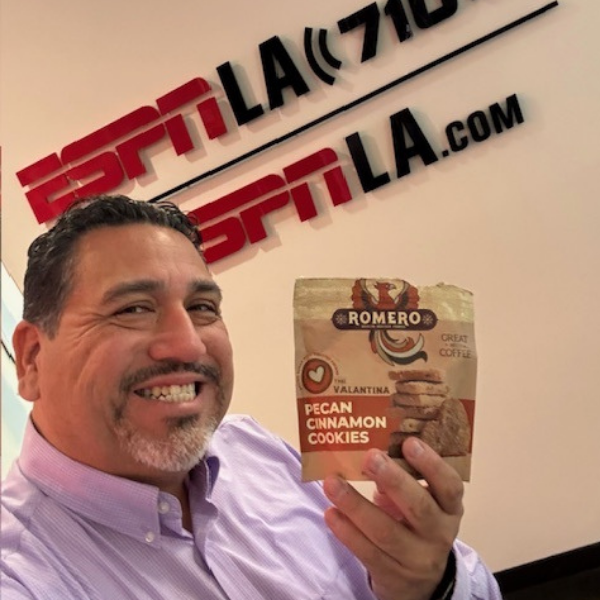 employee as espn showing off a cookie bag and smiling