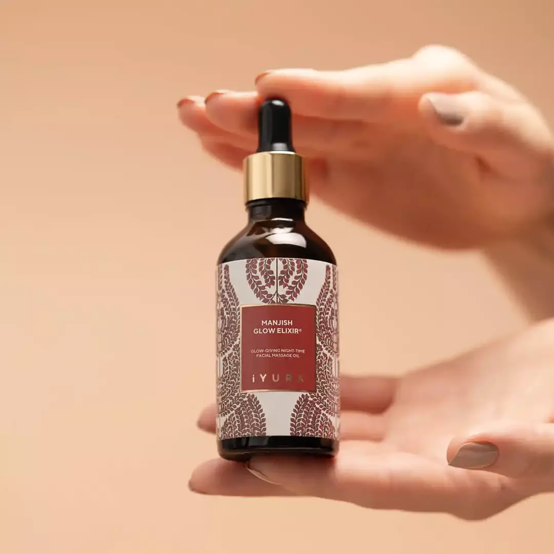 hand holding manjish bottle 1