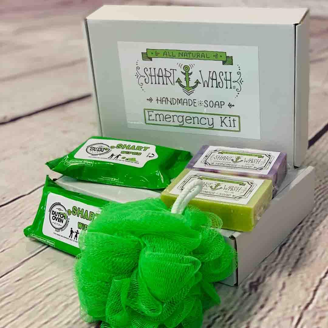 picture of shart wash emergency kit gift box with 2 green packs of shart wipes hand and surface wipes, 2 bars of shart wash soap (assorted colors) and 1 green loofah