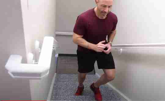 Fit Man Red Shirt Shorts Running Up Stairs