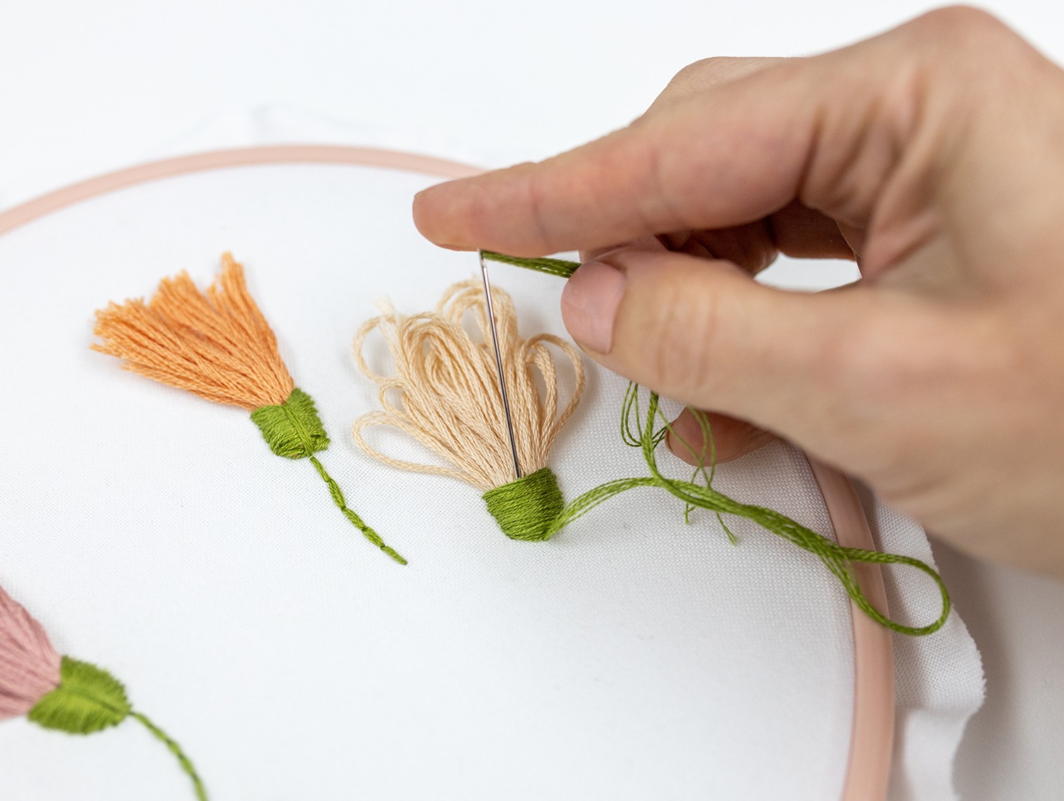 A needle creates a thread bundle flower.