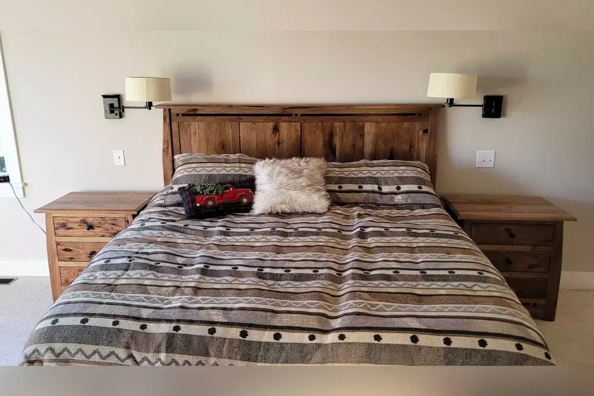 Rustic hickory queen bed with matching nightstands and wood grain detail in a cozy neutral bedroom.