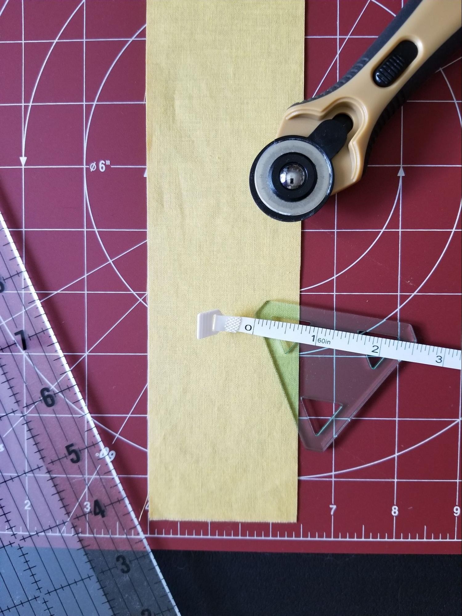 Getting supplies ready to strip cut triangles using a 60 degree triangle quilt template.