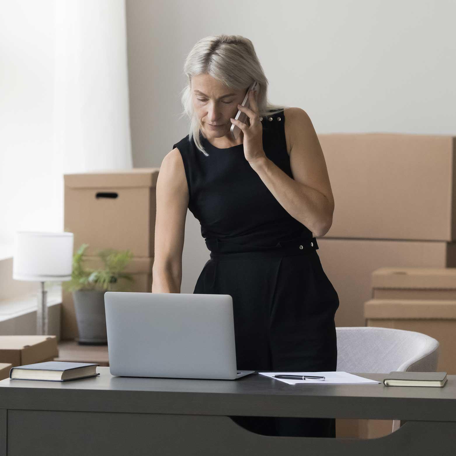 A working individual on the phone and using laptop simultaneously - high screen time.