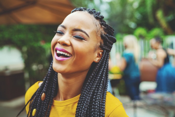 black woman smiling with braids