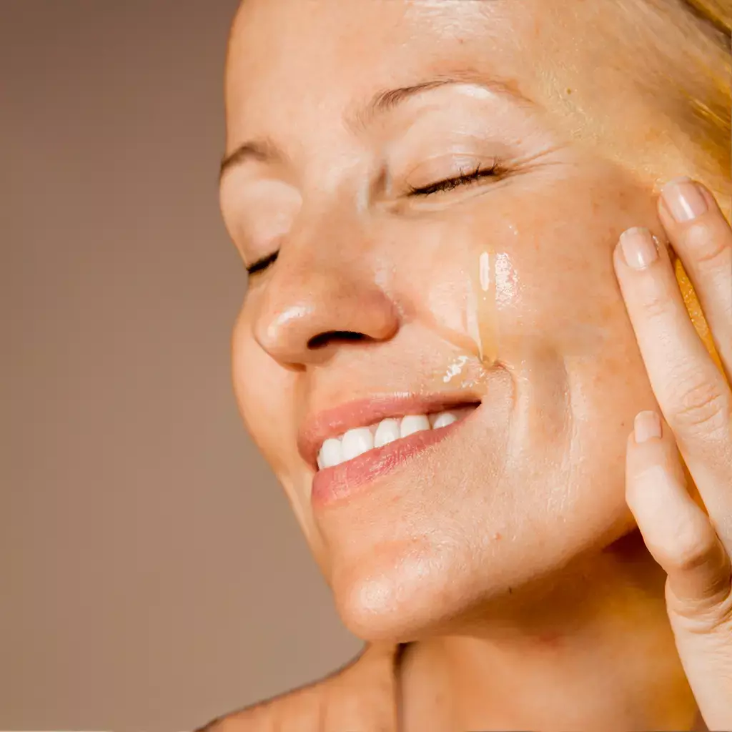 A woman looking happy and satisfied, using the serum