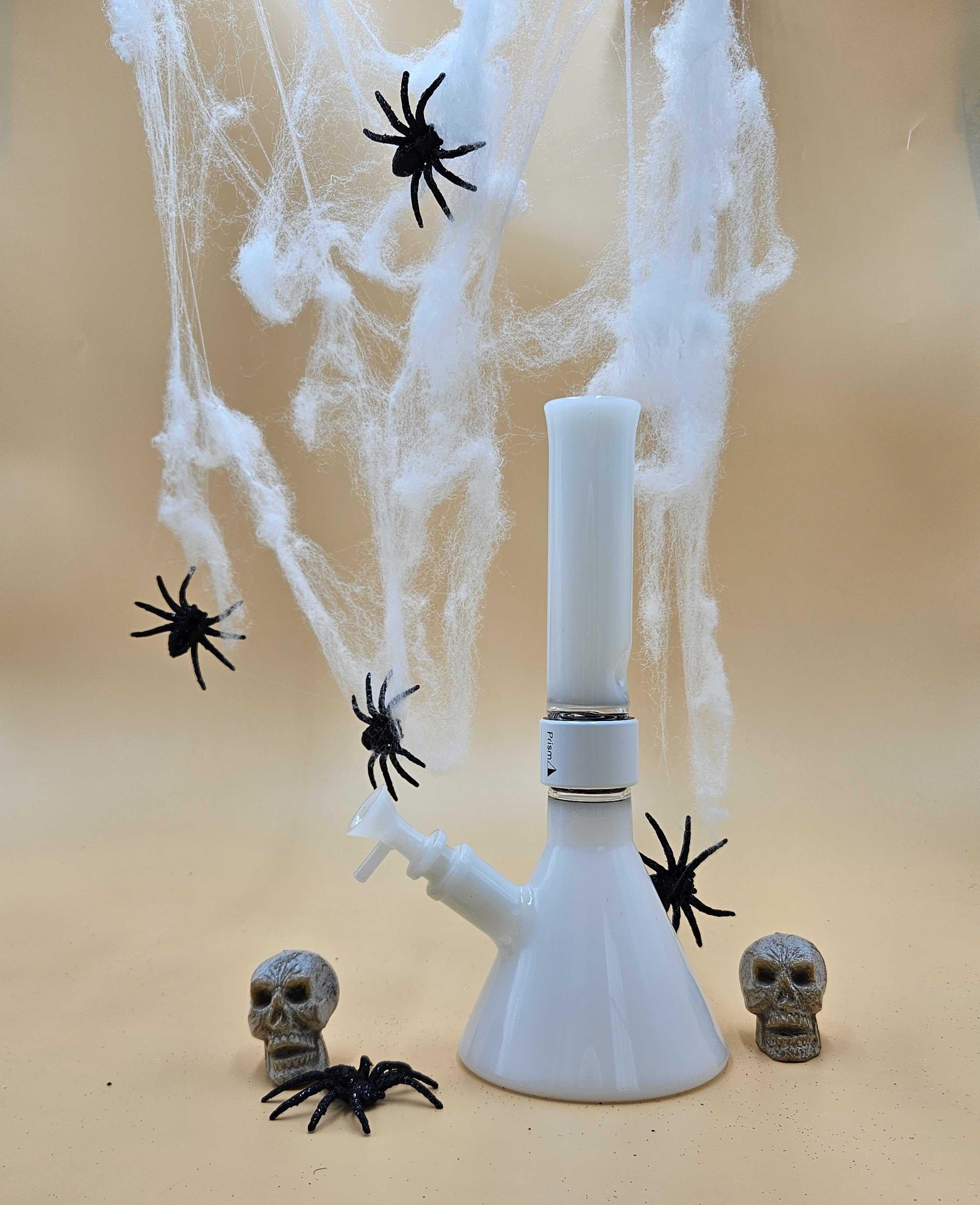 Prism MINI Modular Single Stack Beaker Bong in white set amongst Halloween spooky props, highlighting the portable and discreet best bong for horror movies for an ultimate stoner movie marathon and Final Girl survival guide viewing session.
